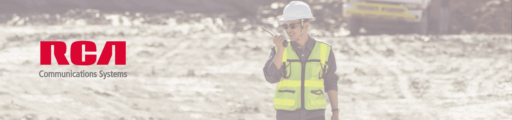 man wearing a safety vest and using a two way radio on the job
